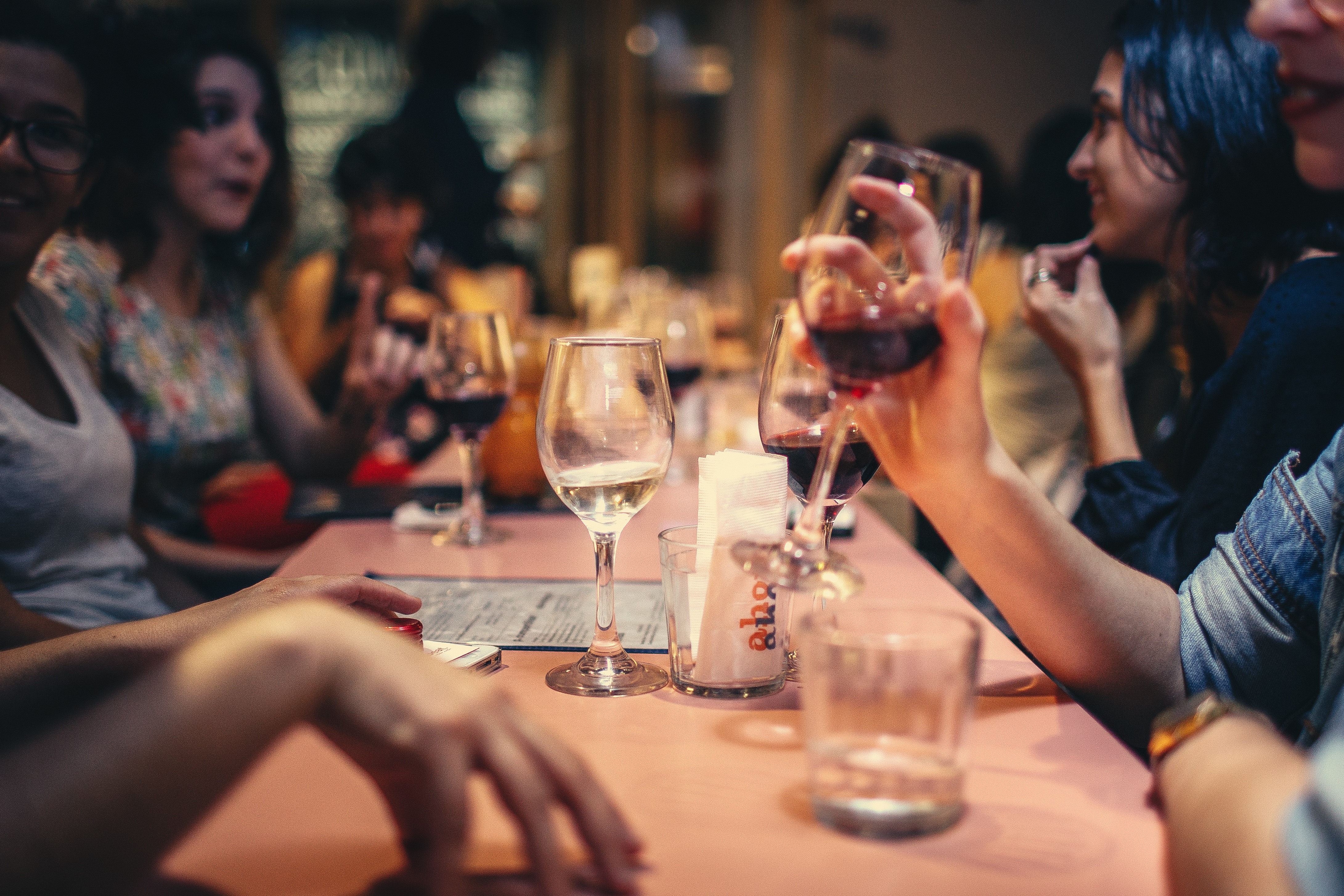 People drinking wine at a bar